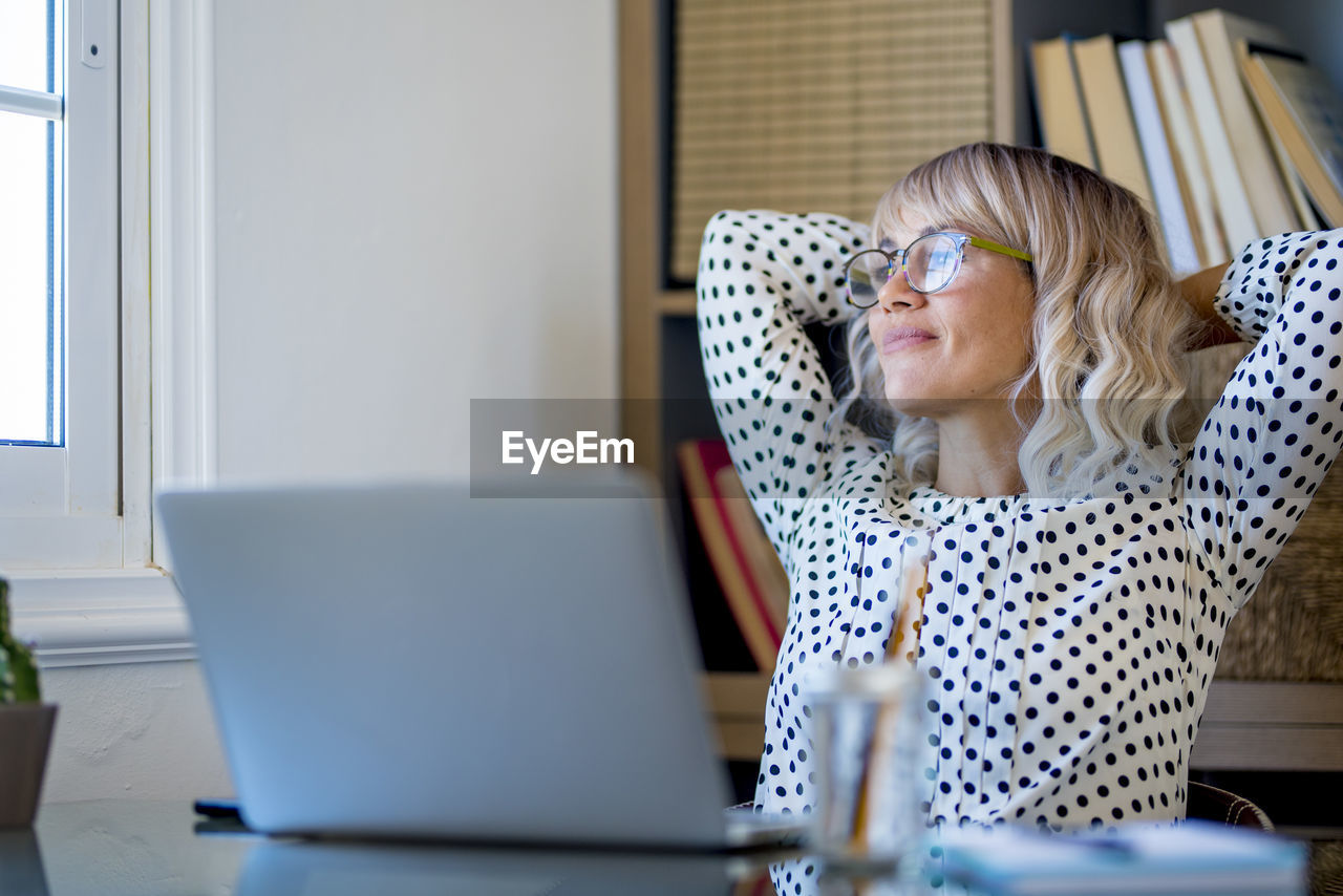 portrait of woman using laptop at home