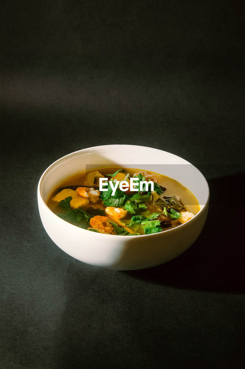 CLOSE-UP OF SOUP IN BOWL ON TABLE