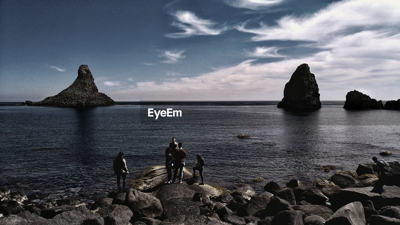 PANORAMIC VIEW OF ROCKS ON SHORE AGAINST SKY