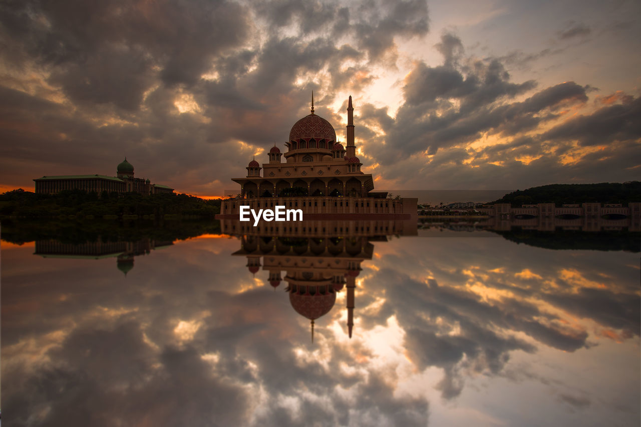 REFLECTION OF TEMPLE IN CITY AGAINST SKY