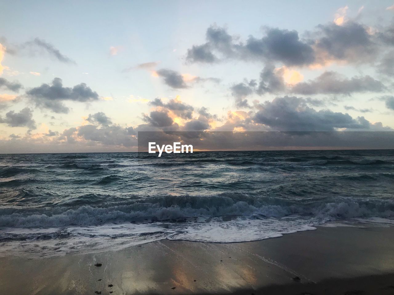 SCENIC VIEW OF BEACH DURING SUNSET