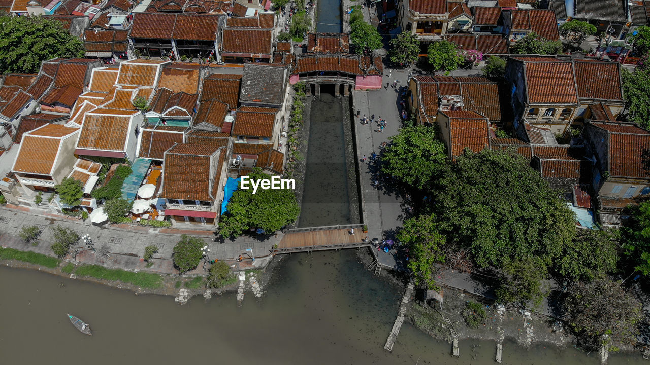 HIGH ANGLE VIEW OF BUILDINGS AND TREES BY STREET