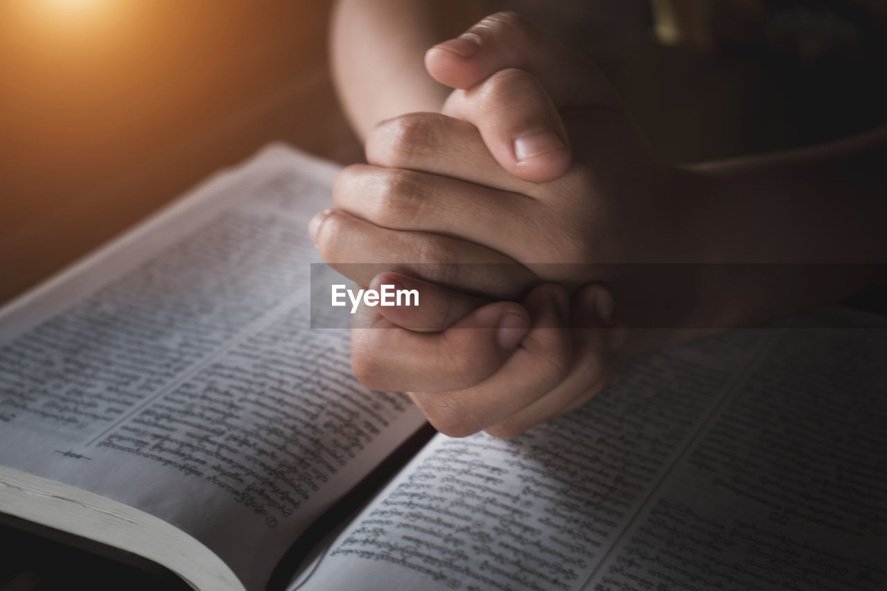 Close-up of hand holding book