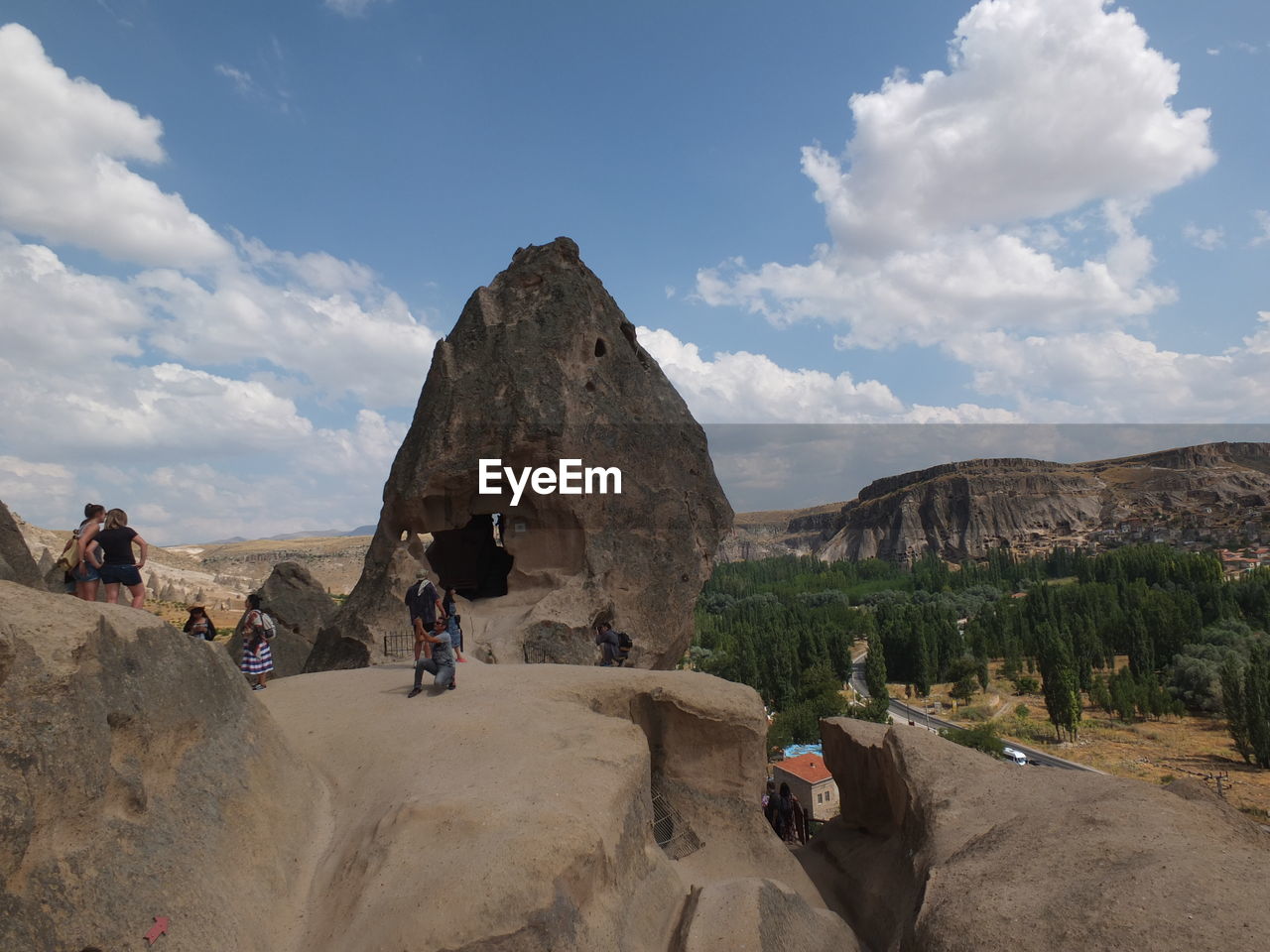 PEOPLE STANDING ON ROCK