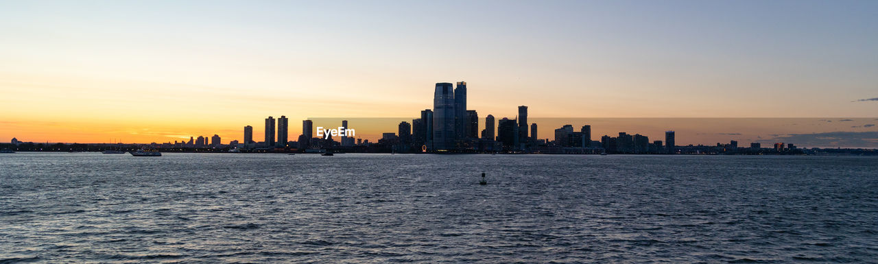 Jersey city silhouetted against a dramatic sunset