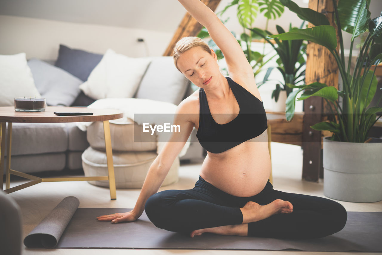 Pregnant woman exercising at home