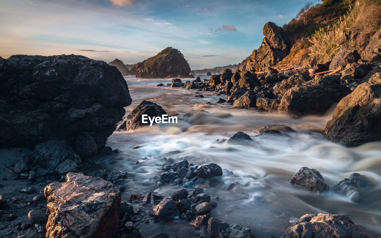 Scenic view of low tide and rocks