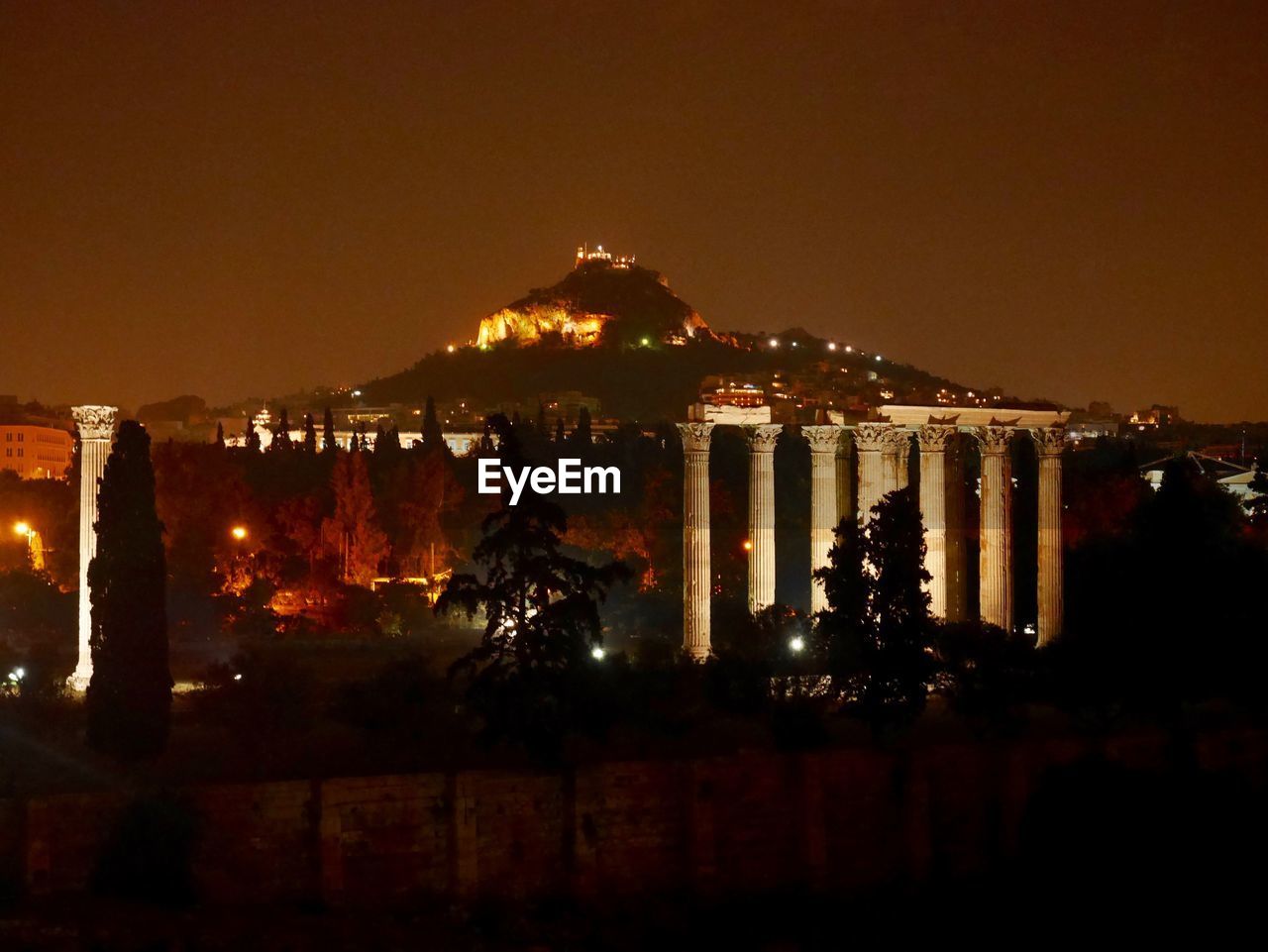 ILLUMINATED CITY AGAINST SKY AT NIGHT