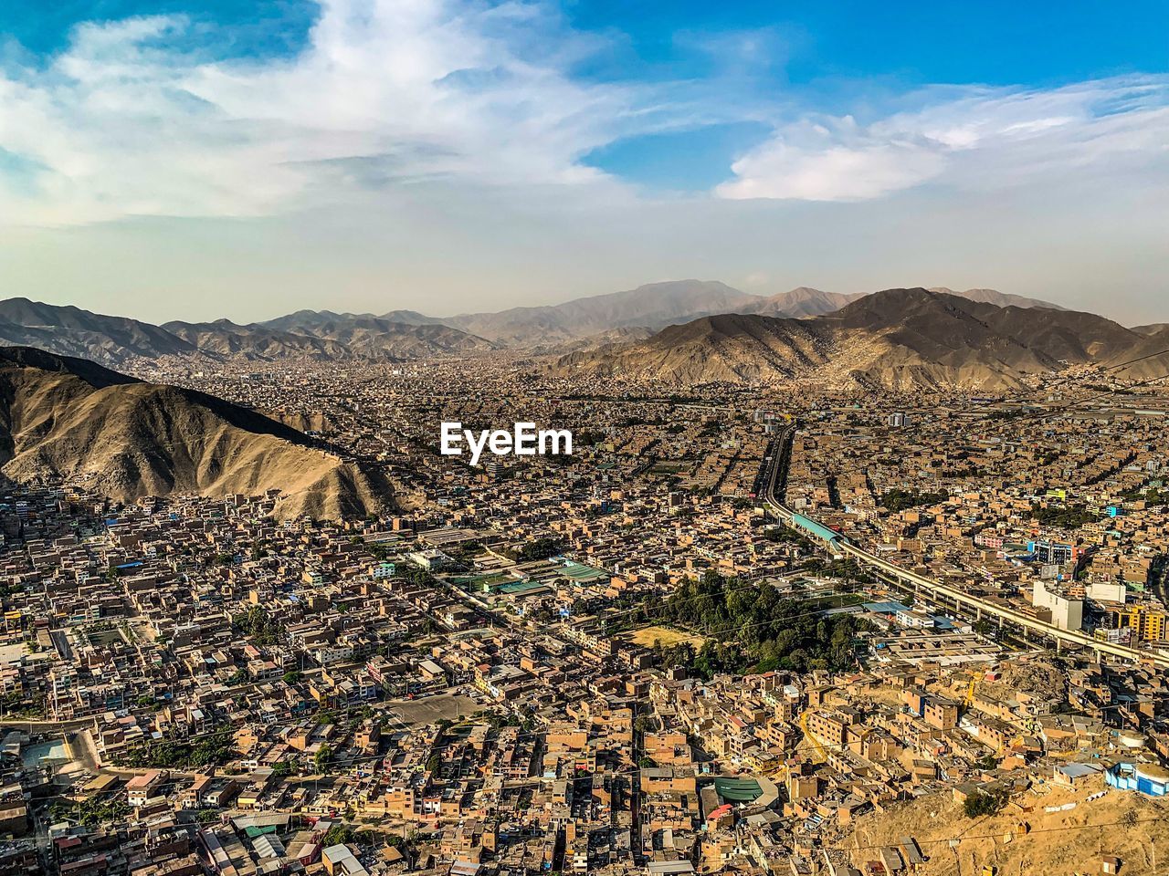 High angle view of city against cloudy sky