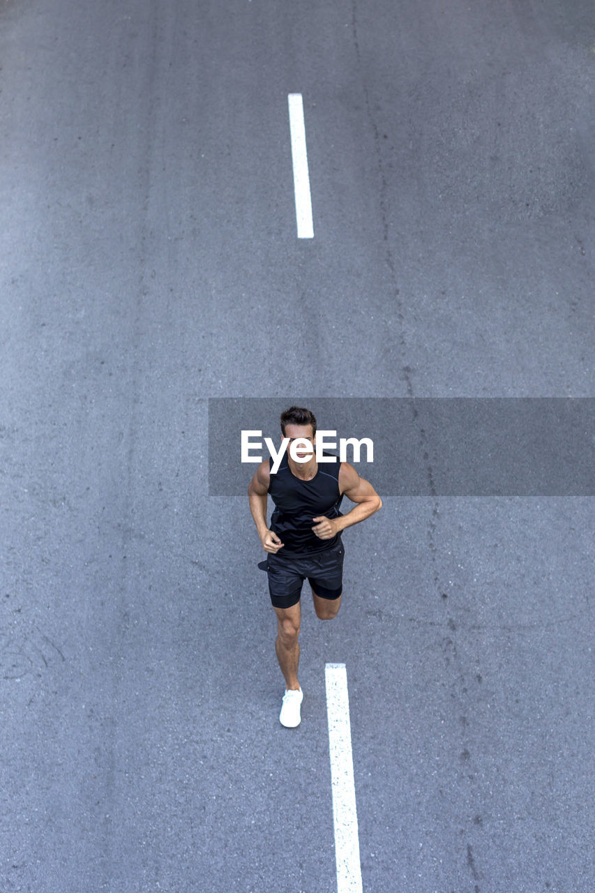 High angle view of man running on road