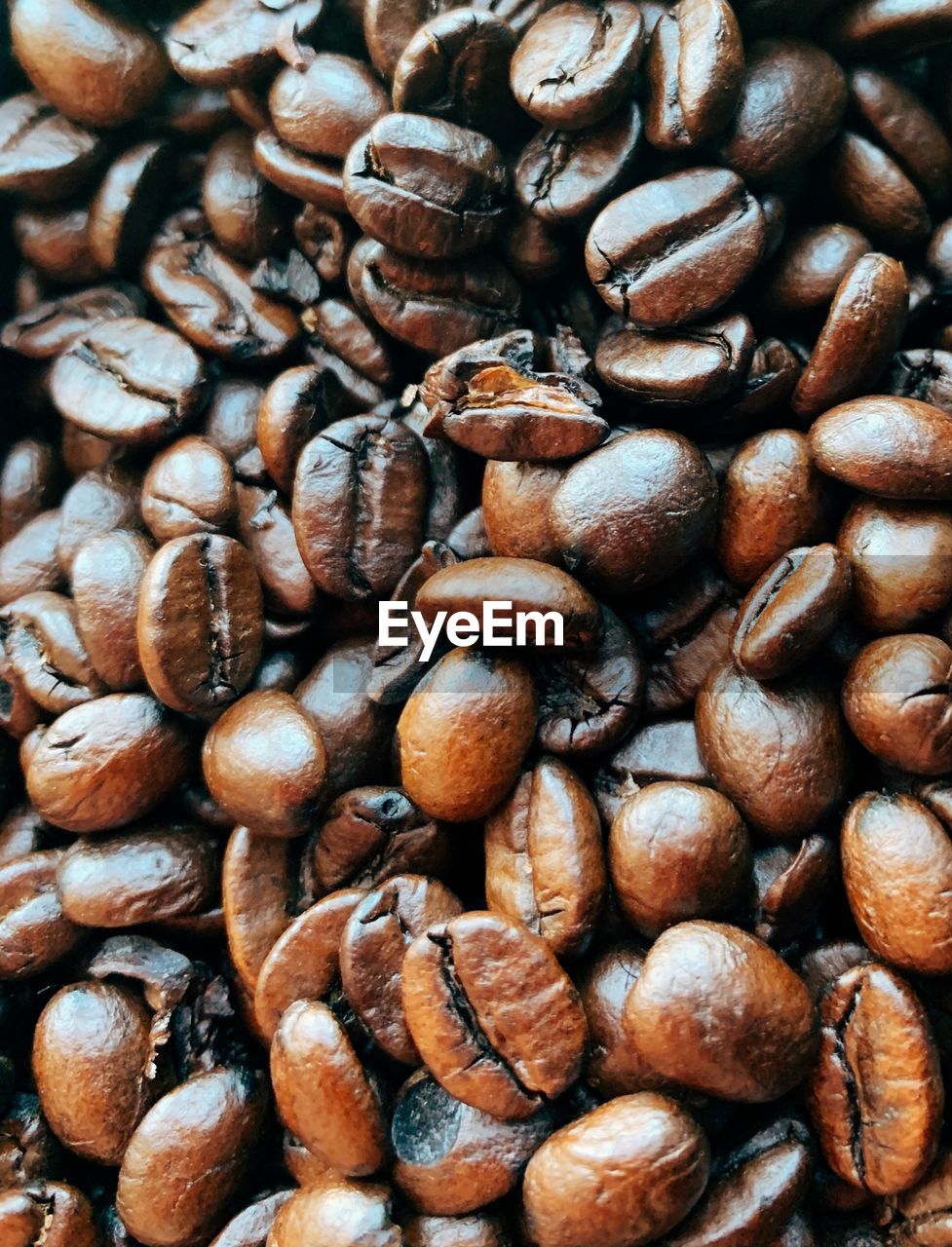 FULL FRAME SHOT OF COFFEE BEANS IN BACKGROUND