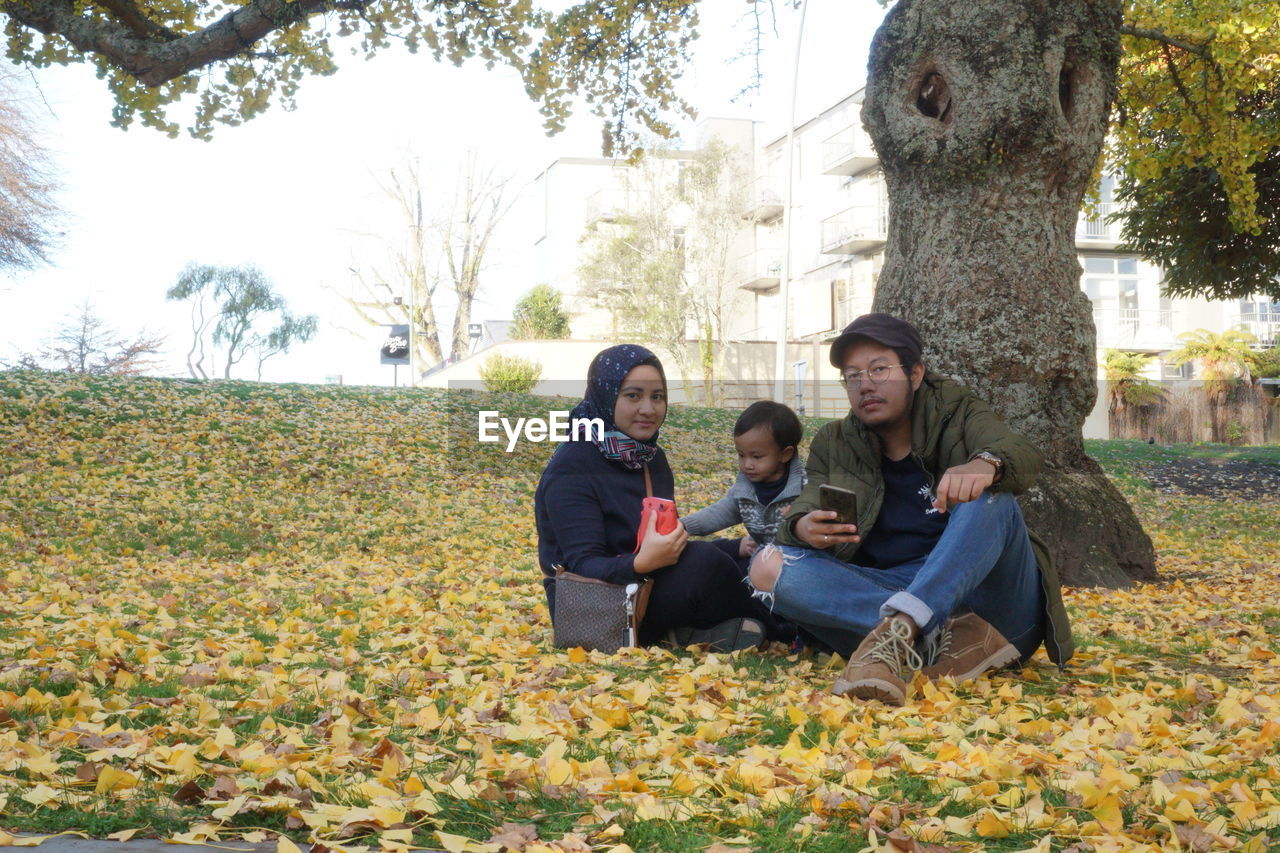Portrait of family sitting on field