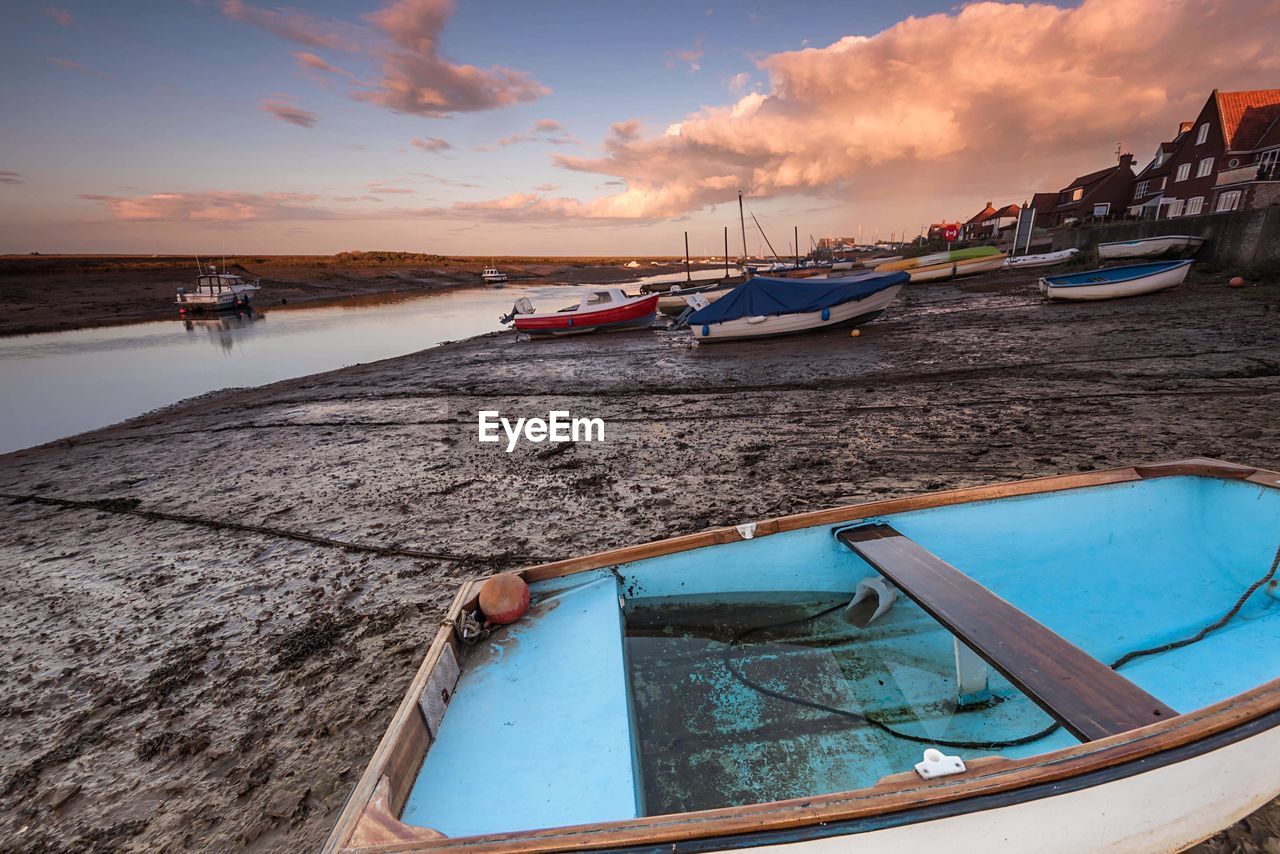 BOATS MOORED ON SEA AGAINST SKY