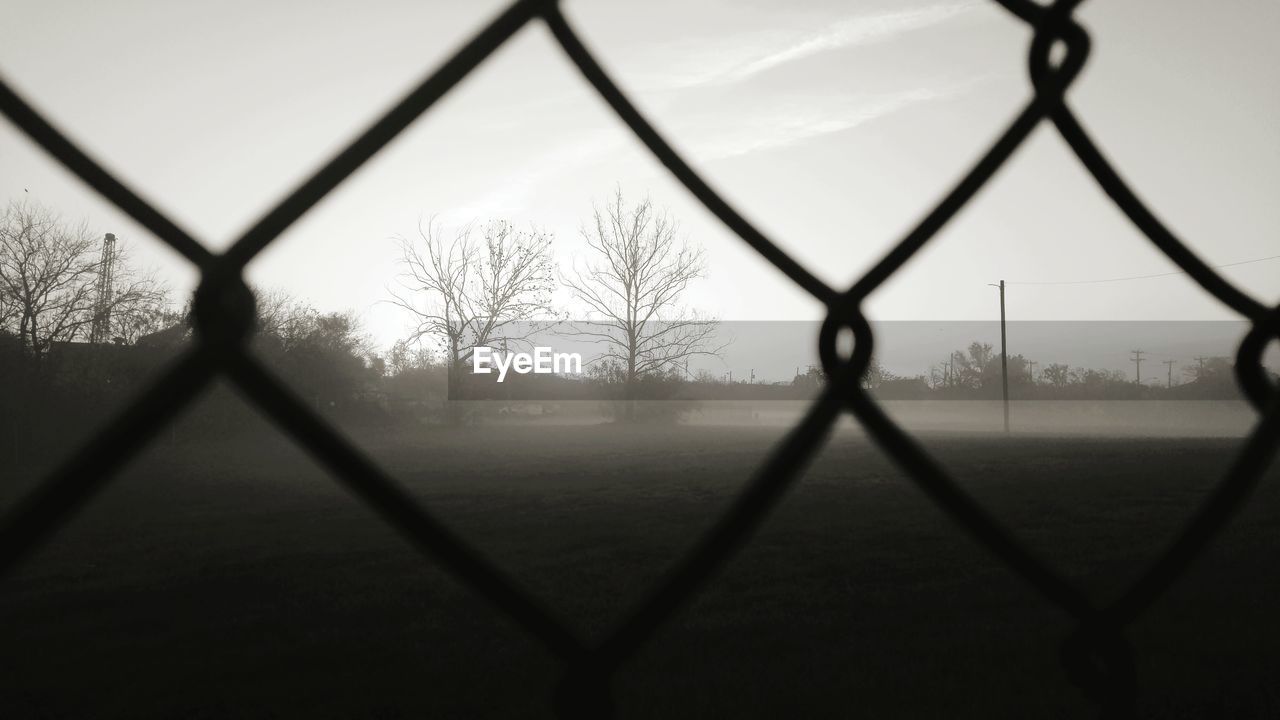 Landscape against sky seen through foggy weather