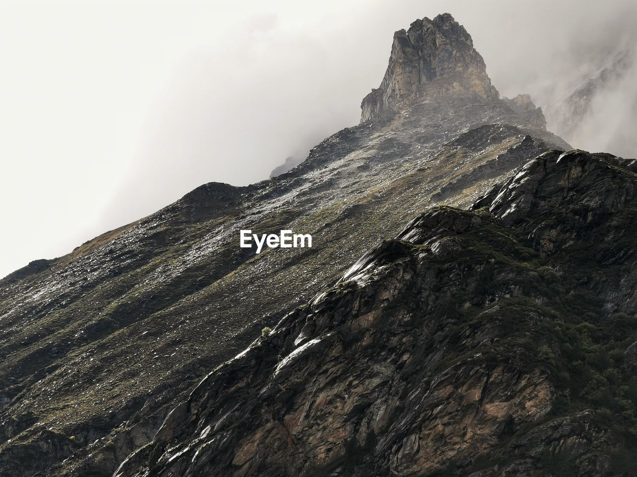 Low angle view of rocky mountains against sky