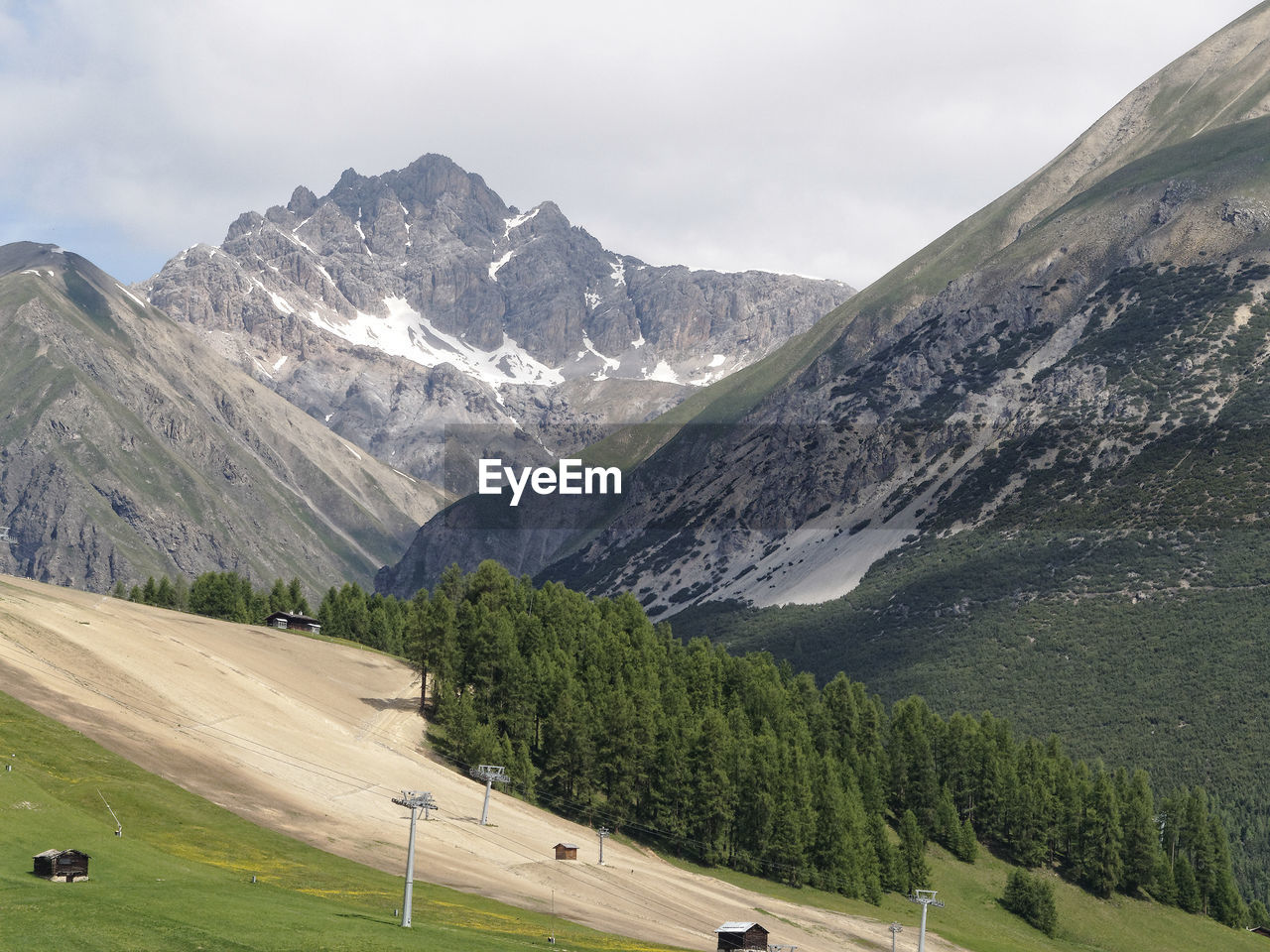 Scenic view of snowcapped mountain against cloudy sky