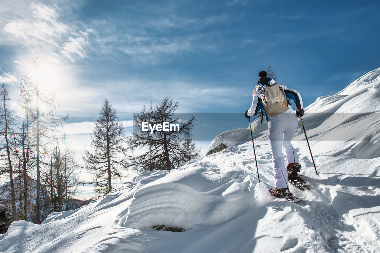 A woman on a snowshoeing trip on a sunny day