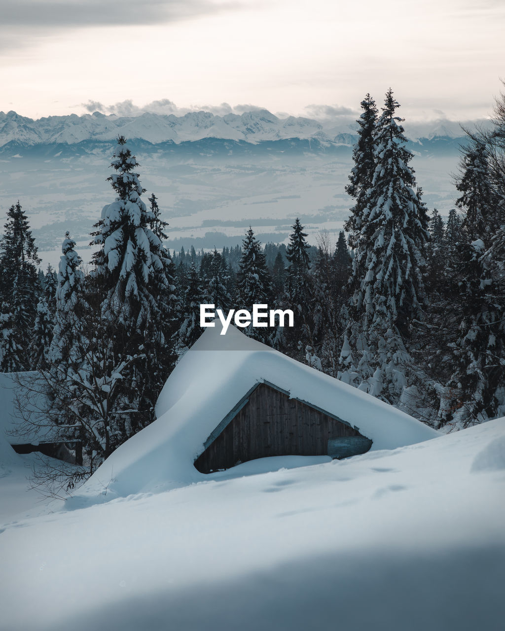 Scenic view of snow covered mountains against sky