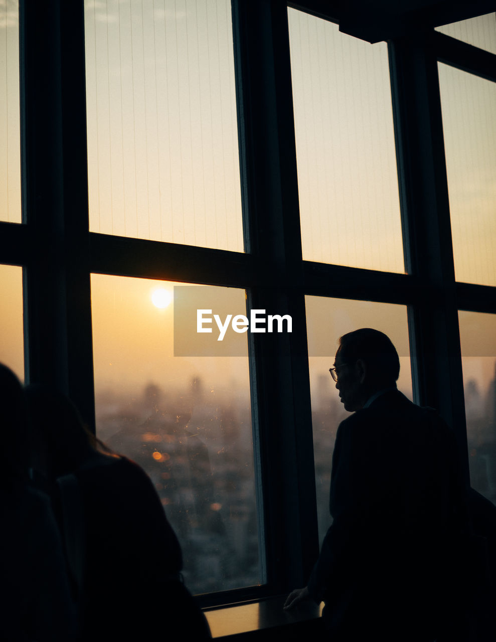 SILHOUETTE OF MAN IN WINDOW