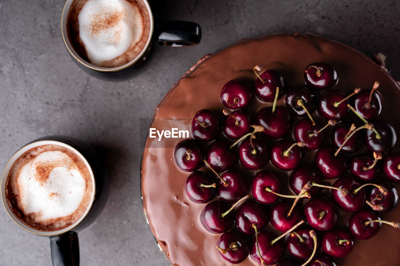 High angle view of cake and coffee cups on table