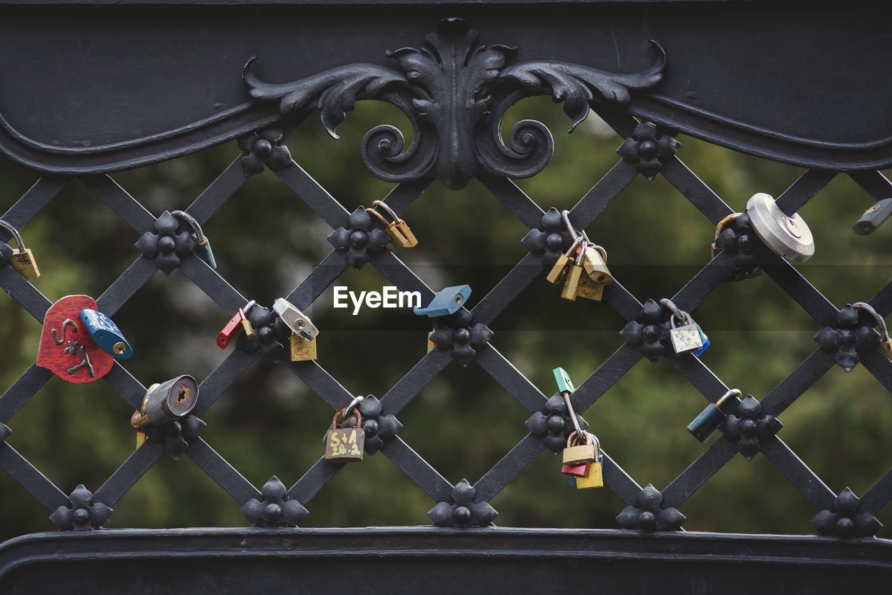 Close-up of padlocks on fence