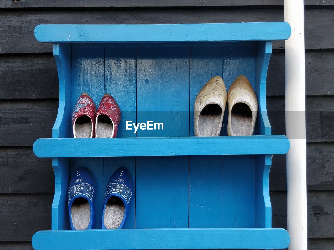CLOSE-UP OF SHOES AGAINST BLUE WINDOW