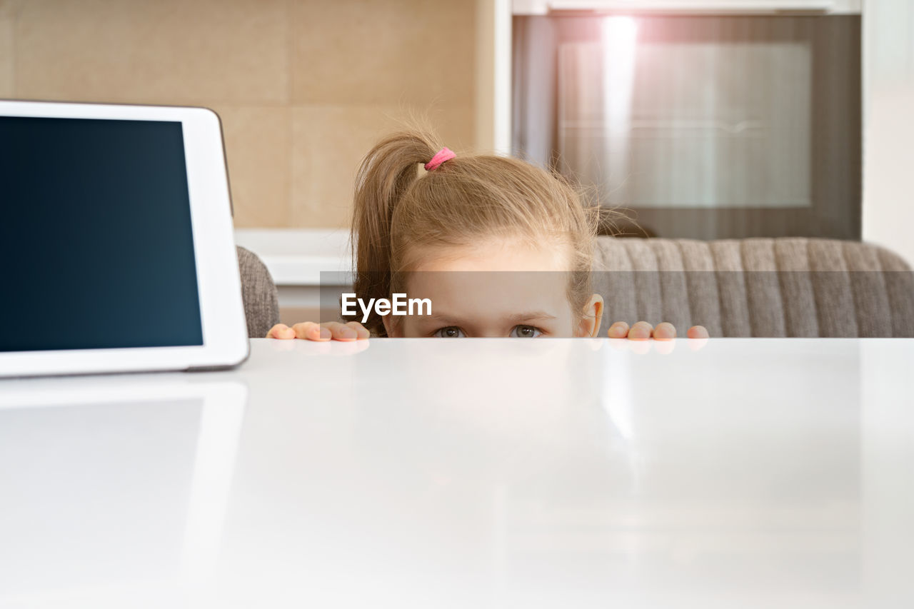 Portrait of girl with smart phone on table