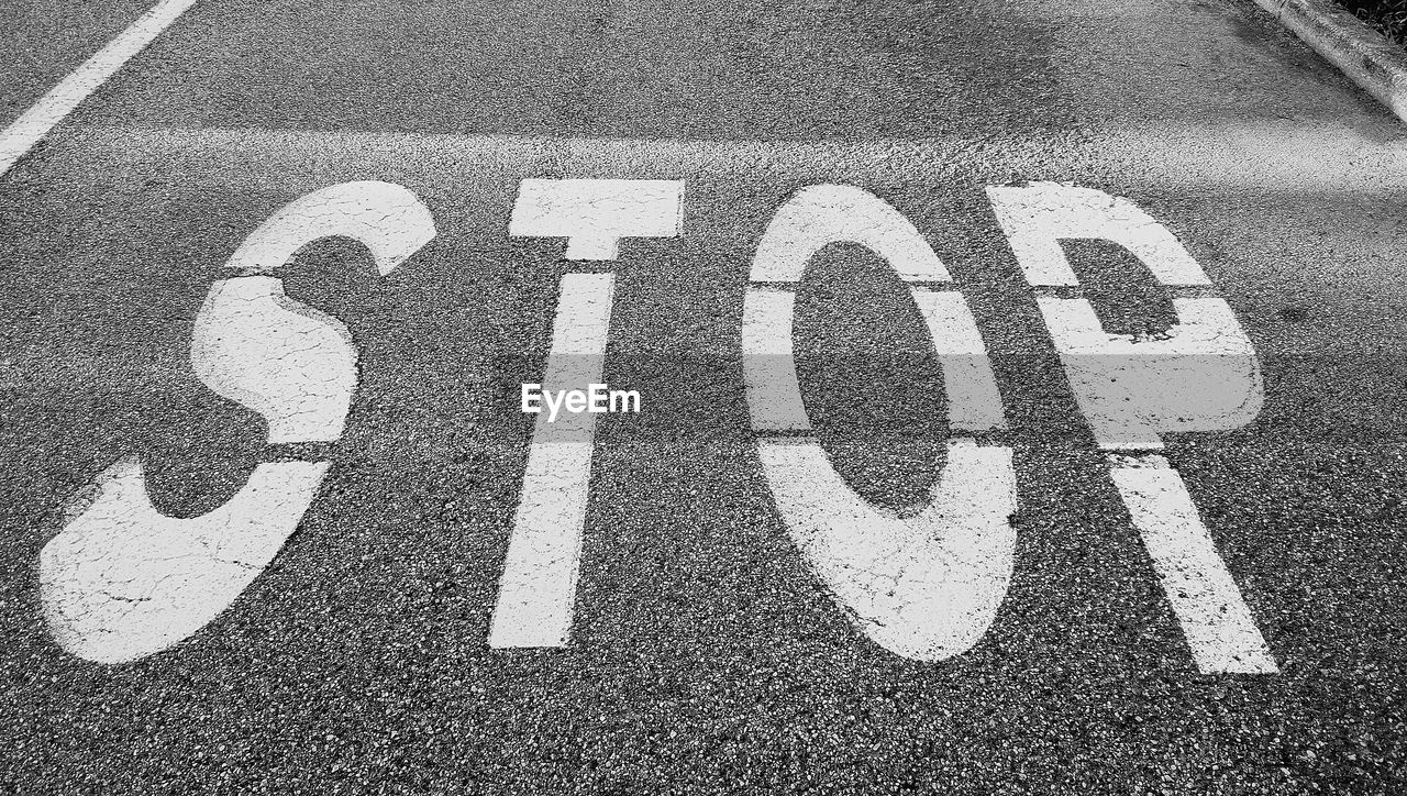 High angle view of text sign on road