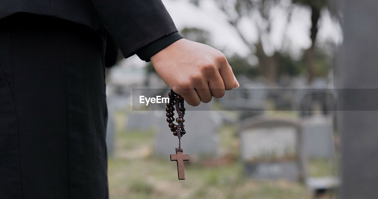 cropped hand of man holding key