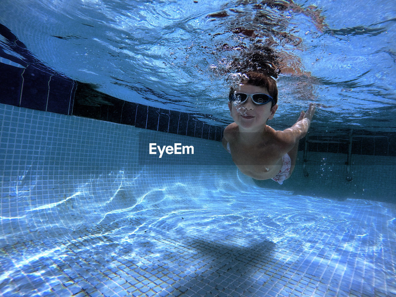 Portrait of boy swimming in pool