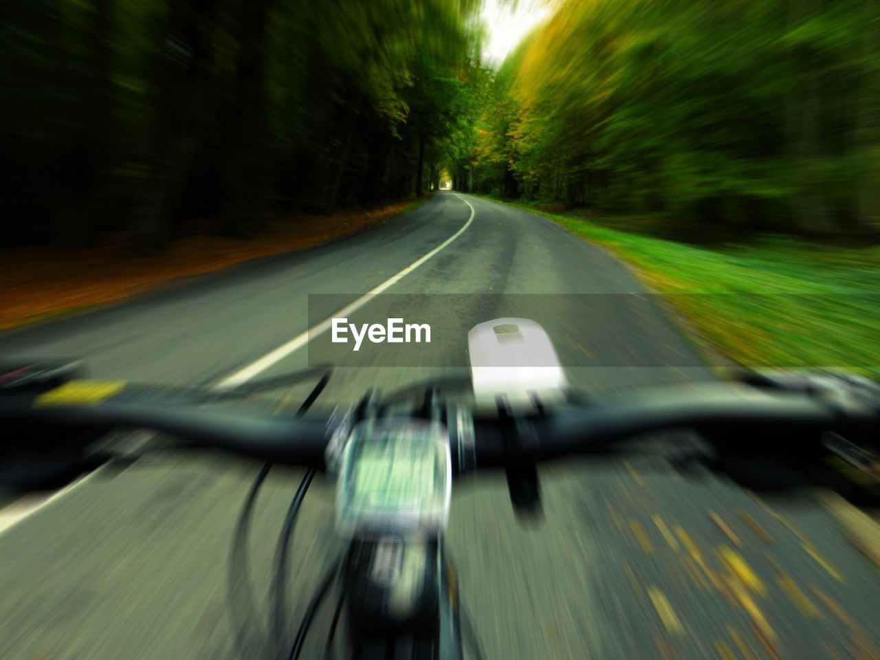 Blurred motion of bicycle on road