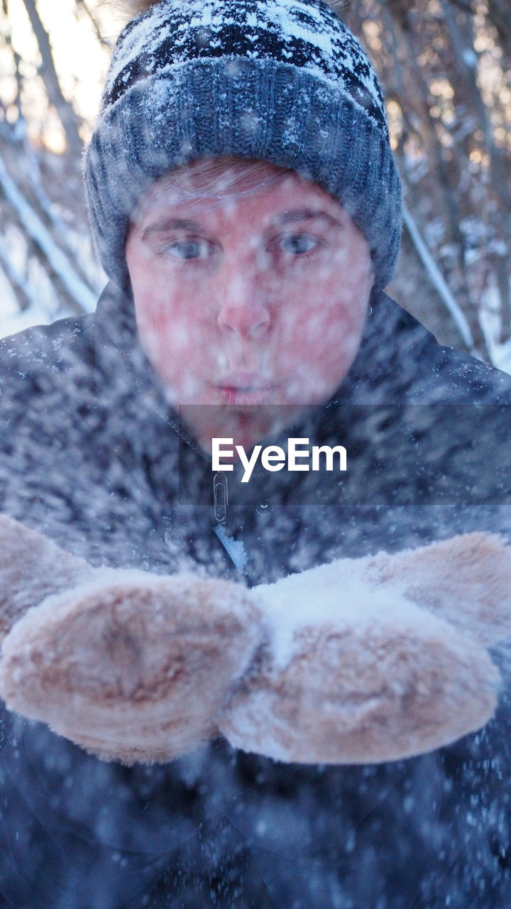 CLOSE-UP PORTRAIT OF MAN WITH SNOW IN WINTER