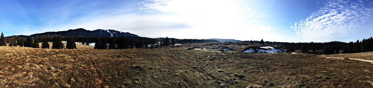 Panoramic view of mountains against blue sky