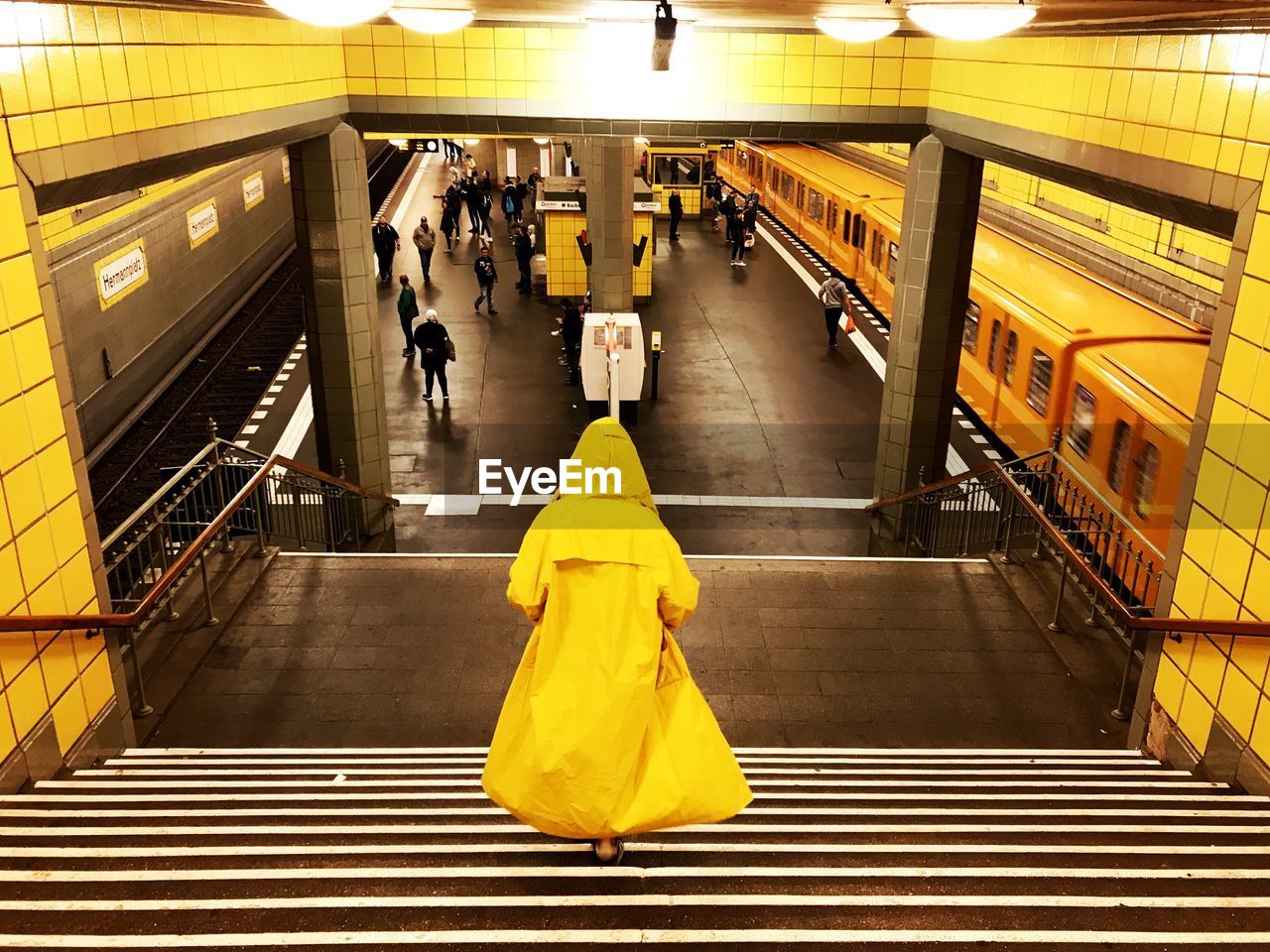 yellow, architecture, subway station, staircase, indoors, escalator, transportation, adult, women, public transportation, subway, railing, steps and staircases, illuminated, lifestyles, group of people, walking, full length, public transport, men, rail transportation, interior design, high angle view, mode of transportation, transport