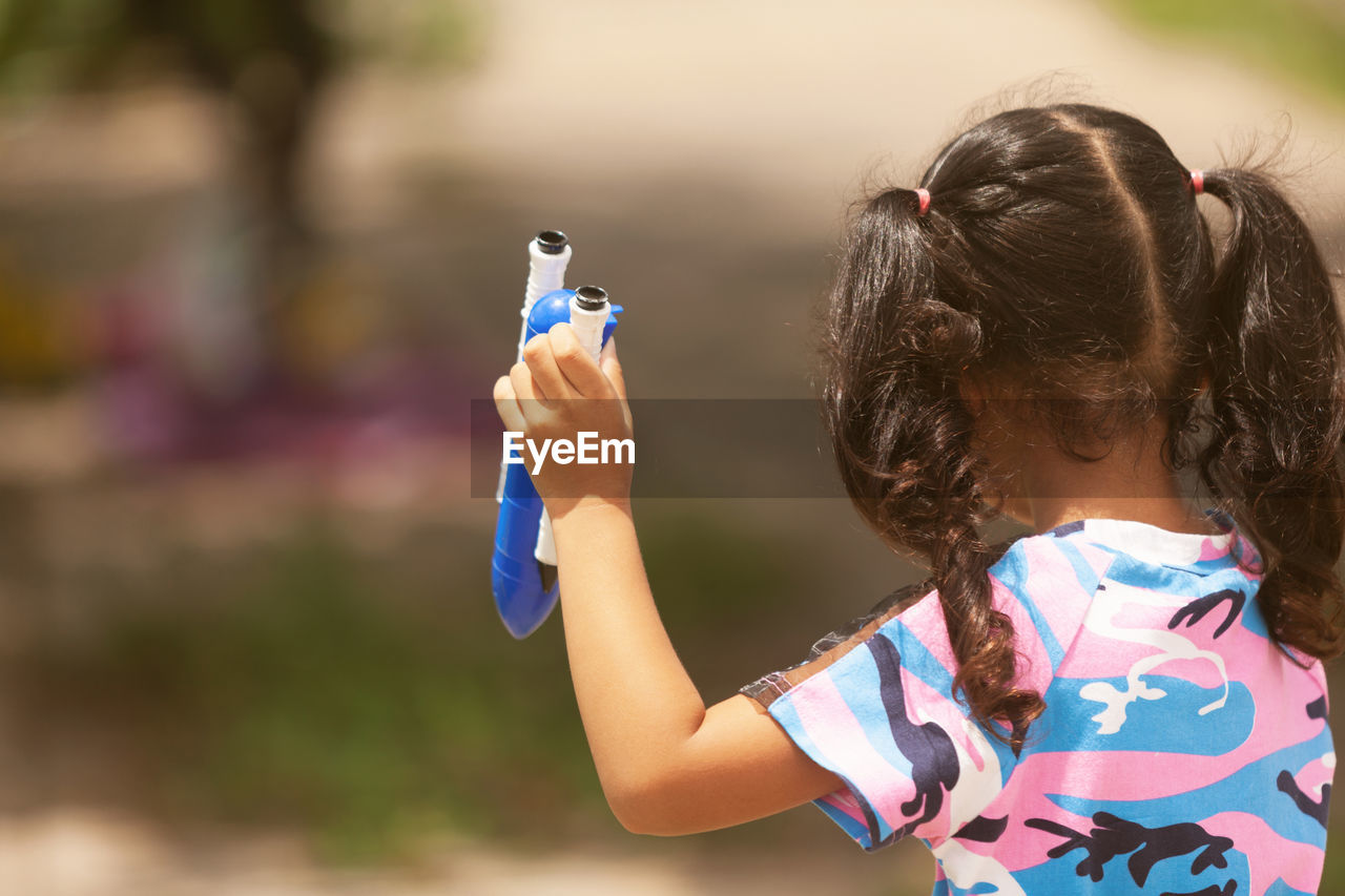 GIRL HOLDING UMBRELLA