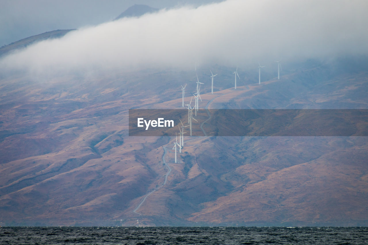 Modern windmills on the hawaiian island of maui generating clean energy