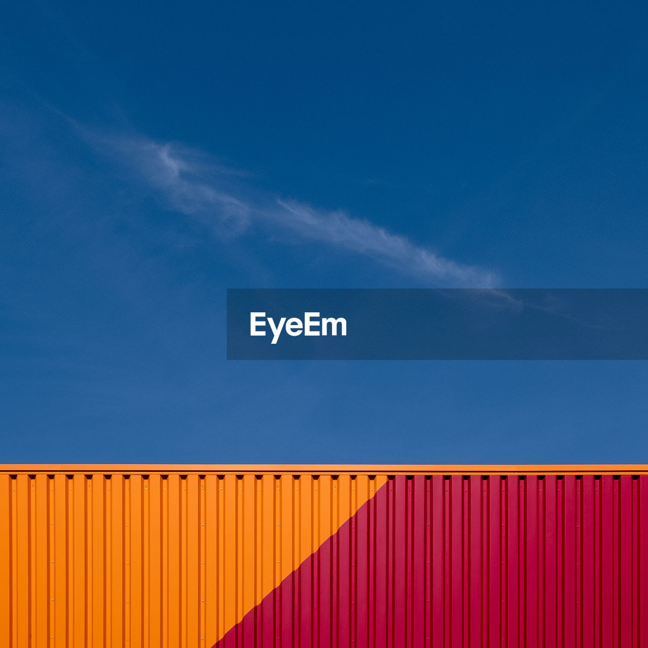 Low angle view of cargo container against blue sky