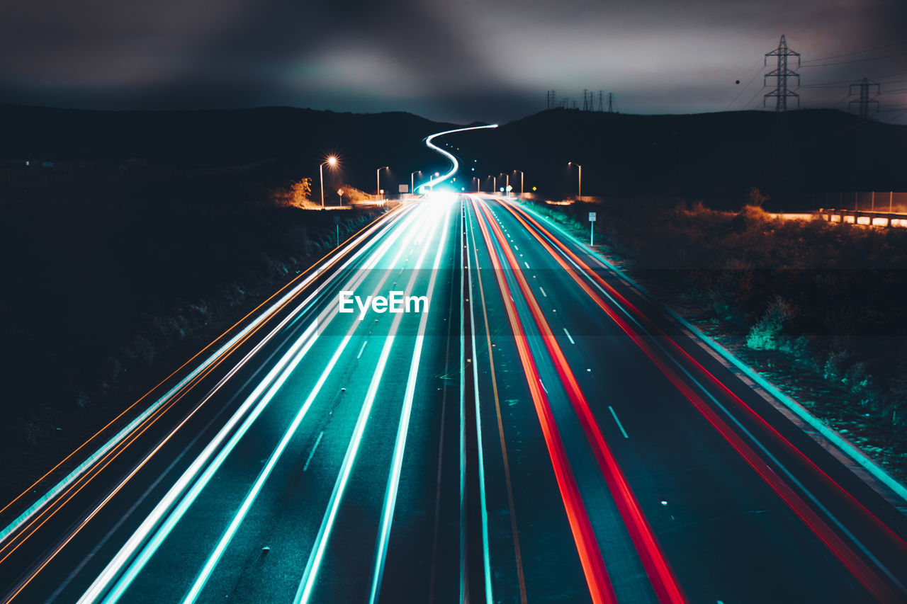 High angle view of light trails on road at night