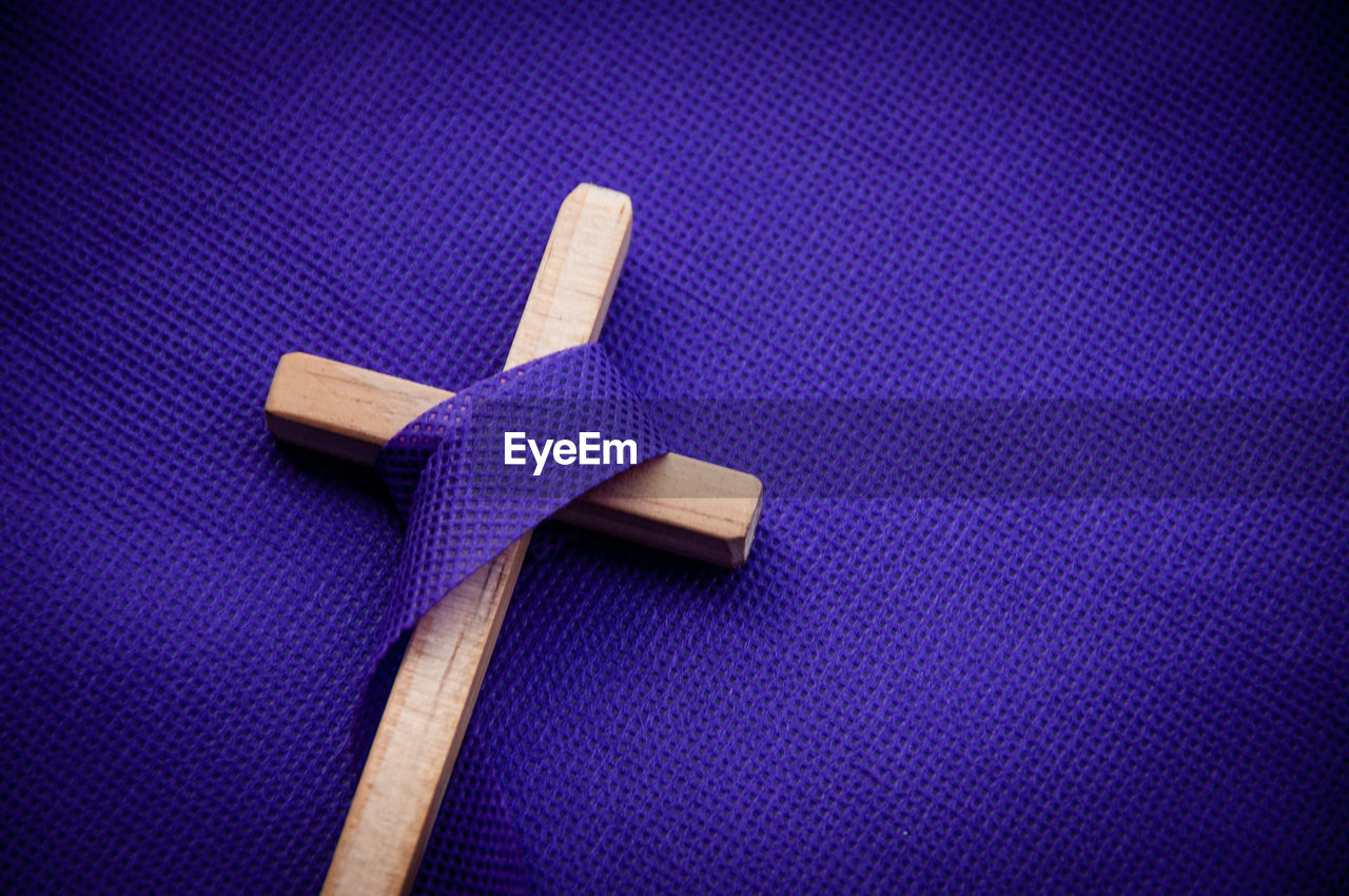Religious cross on purple background. good friday concept