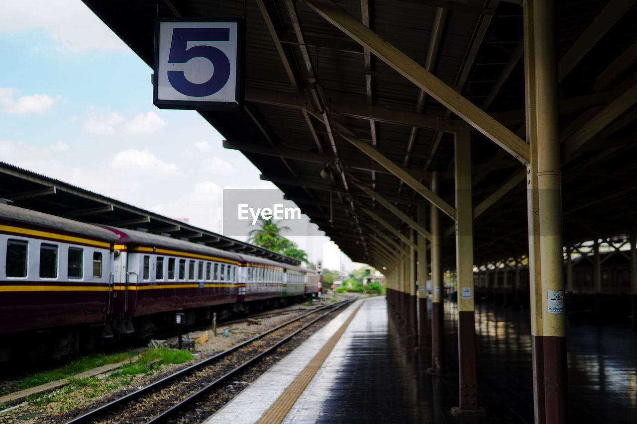 Train at railroad station against sky