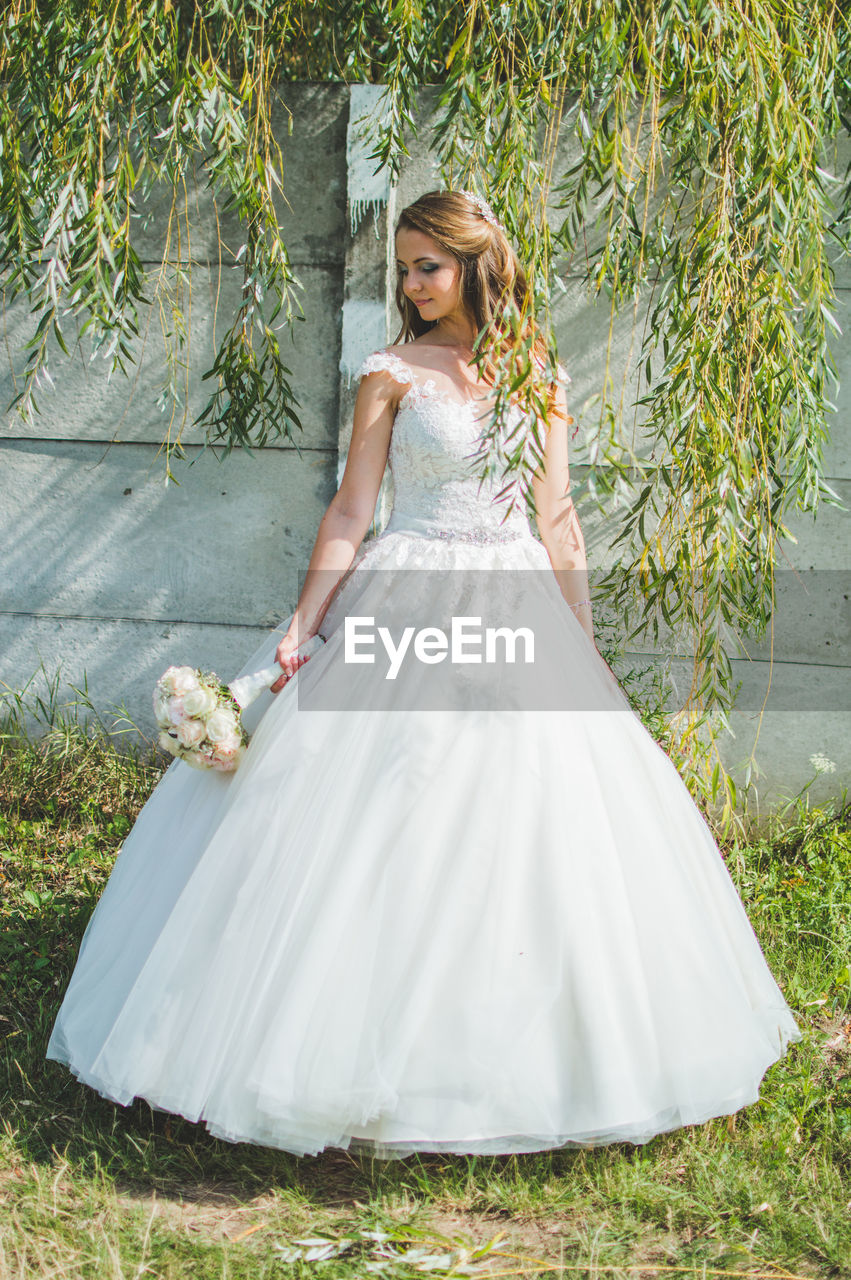 Young bride in front of the plants. 