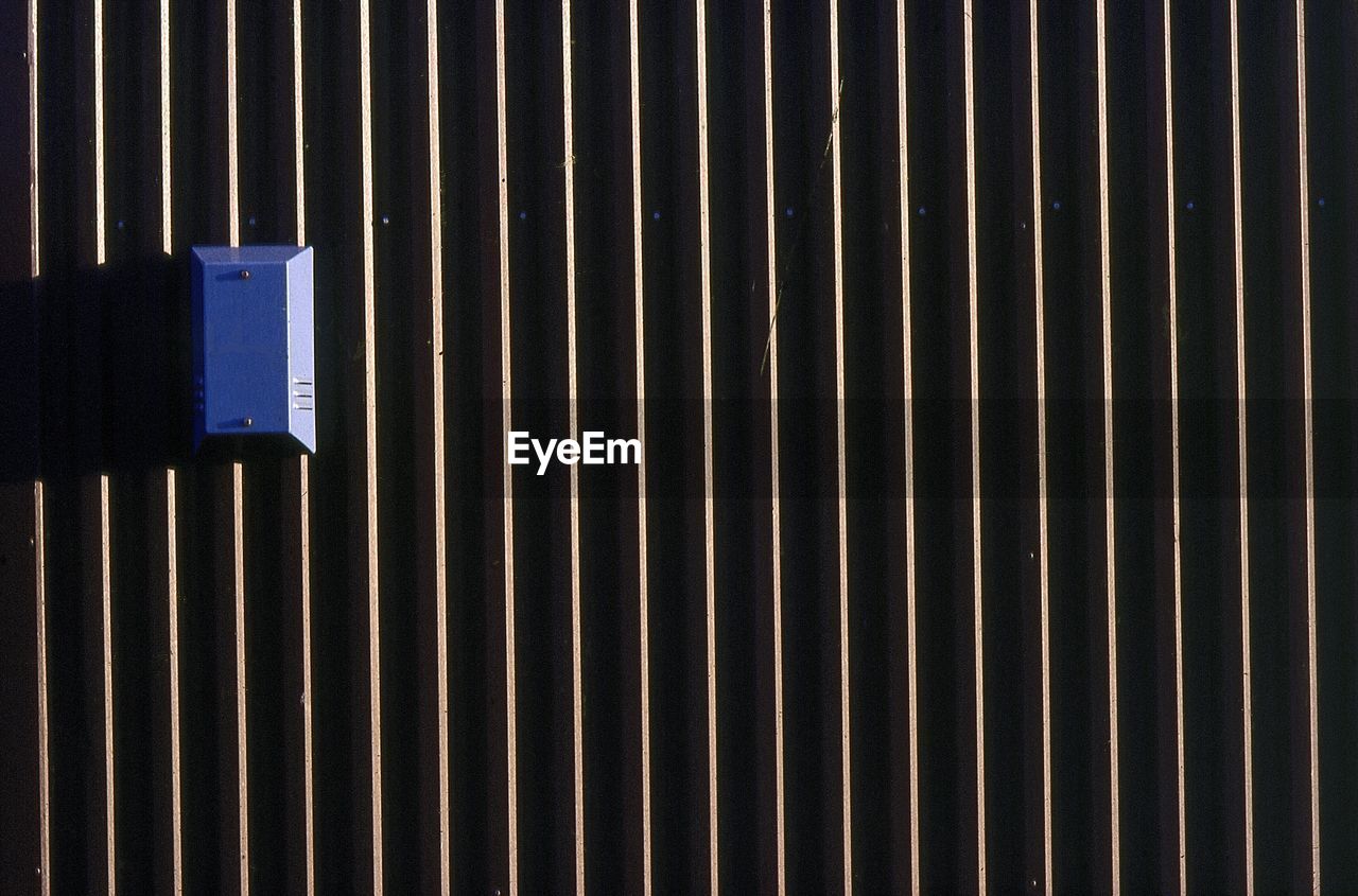 Blue alarm on the outside of an industrial warehouse in sheffield south yorkshire u.k.