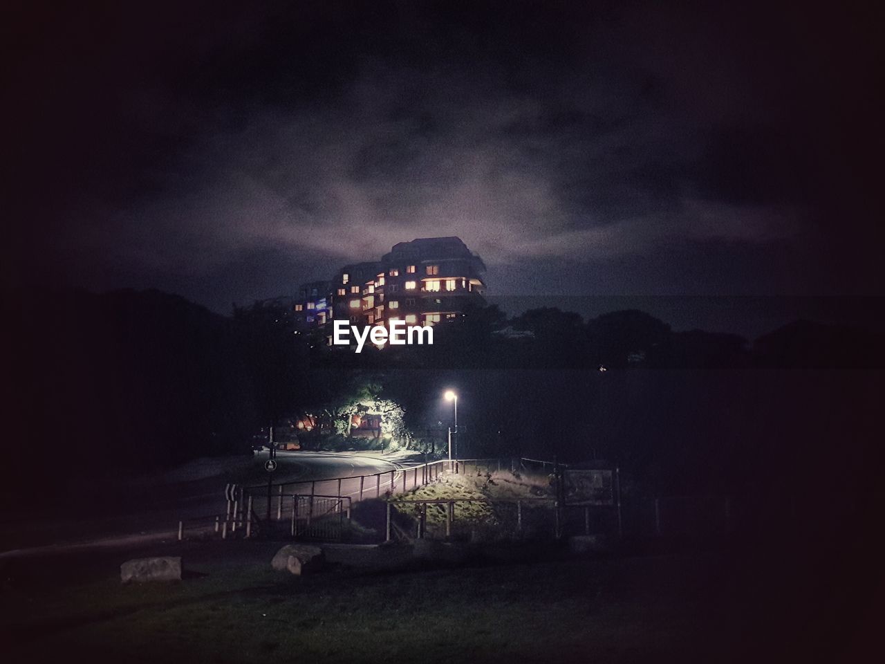 ILLUMINATED BUILDING AGAINST SKY