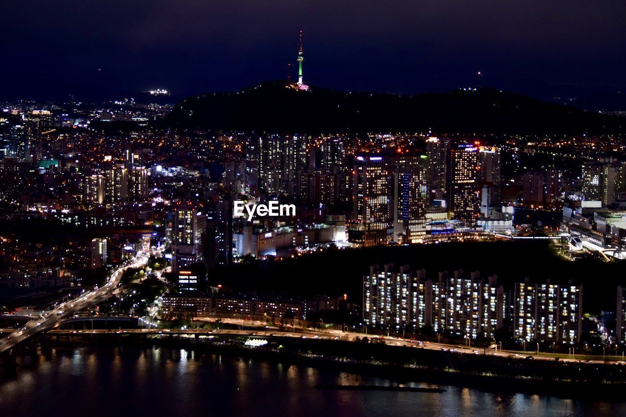 HIGH ANGLE VIEW OF ILLUMINATED CITY BUILDINGS