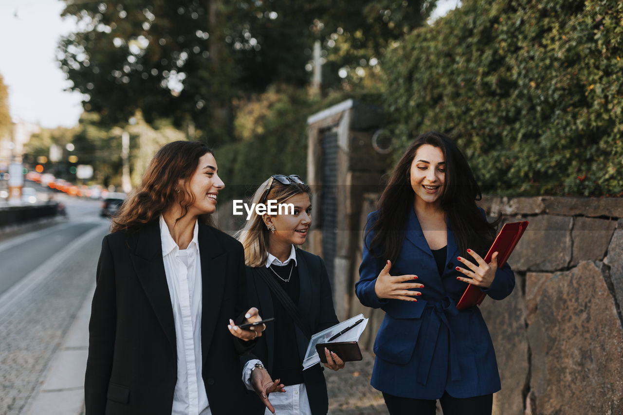 Female coworkers walking together