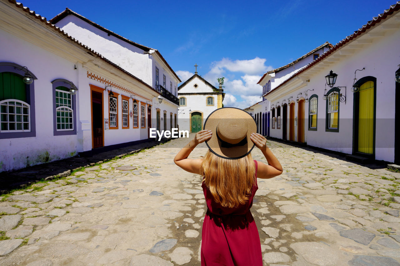 Colonial architecture in latin america. young tourist woman in the historic town of paraty, brazil