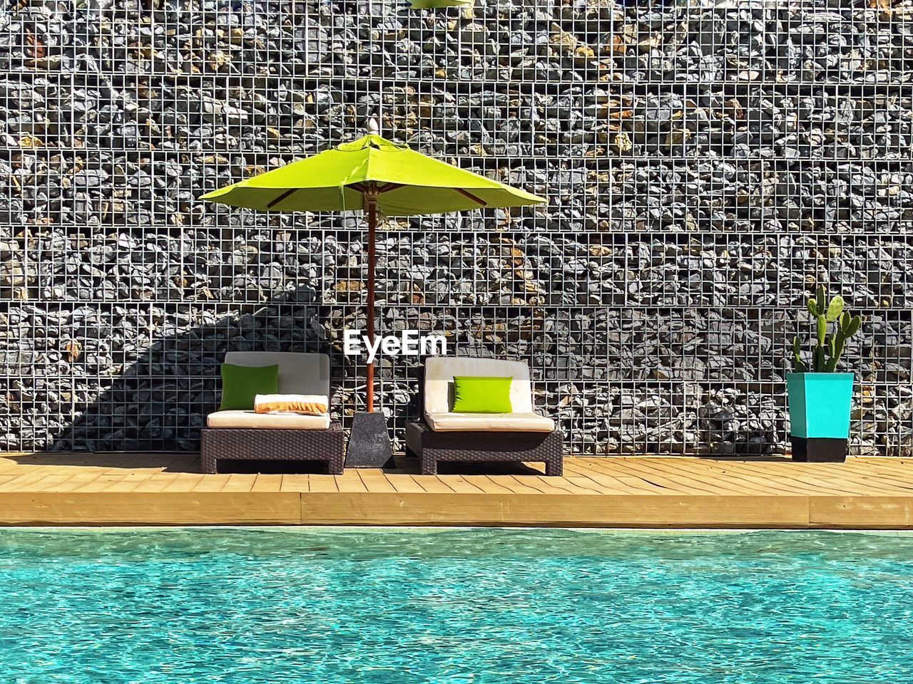 water, umbrella, swimming pool, nature, protection, parasol, day, lounge chair, sunshade, security, chair, outdoors, no people, travel destinations, summer, relaxation, architecture, vacation, trip, sunlight, tourist resort, holiday, poolside, furniture, travel, wealth, beach umbrella, luxury, hotel, seat