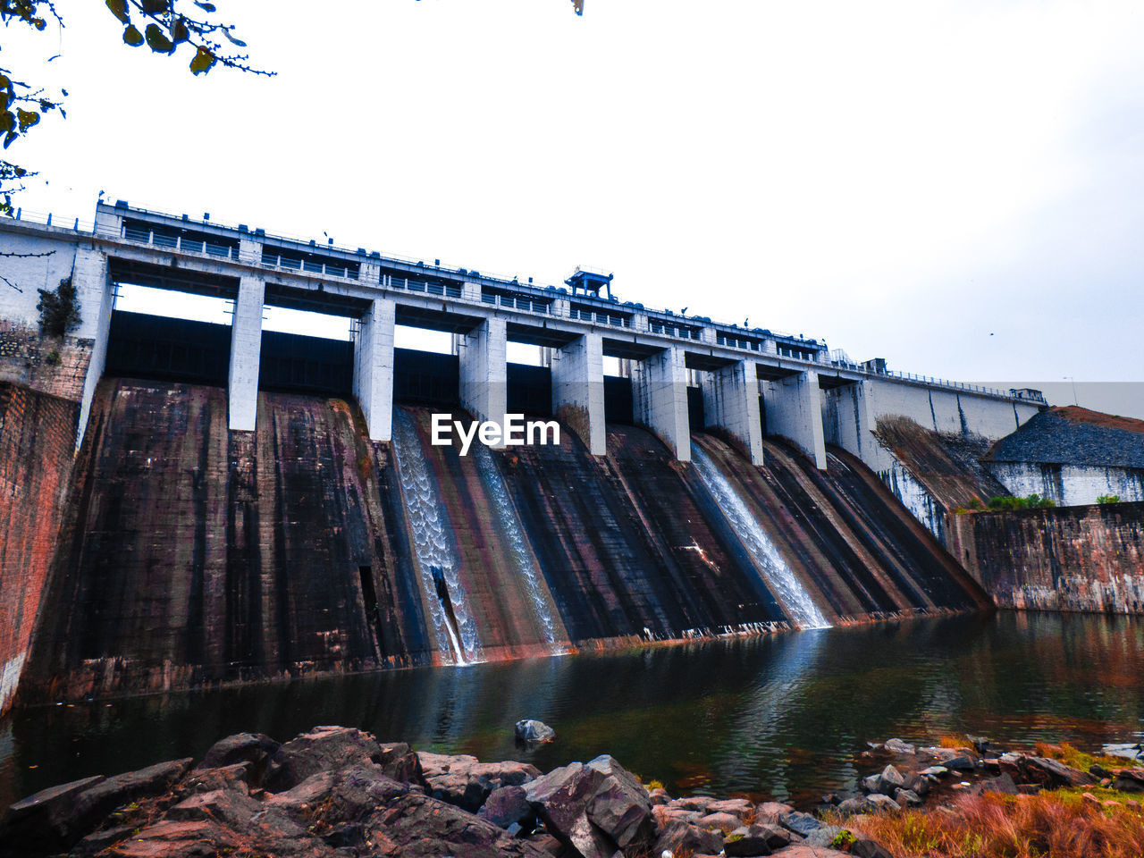 Built structure over dam against sky