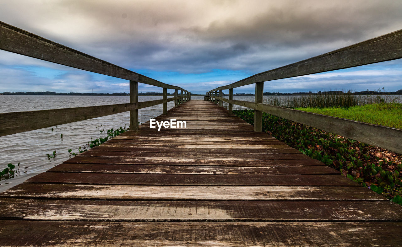 EMPTY FOOTPATH ALONG RAILING