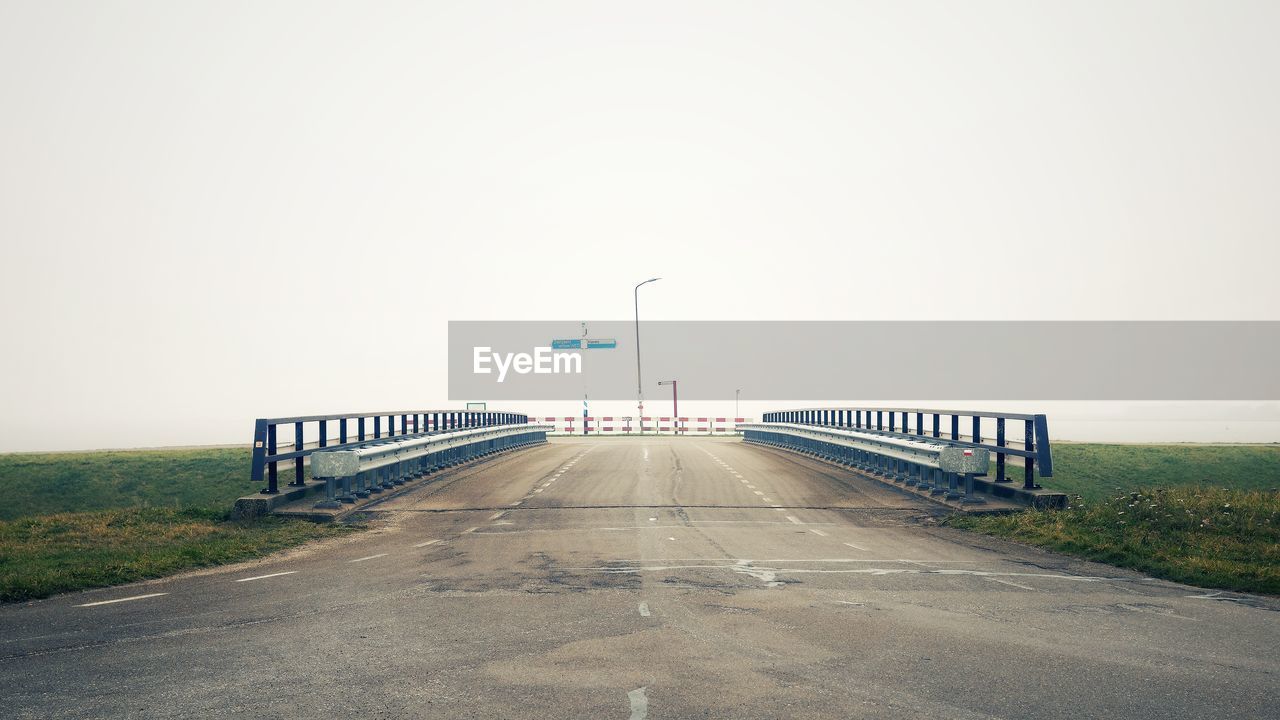 Empty road against clear sky